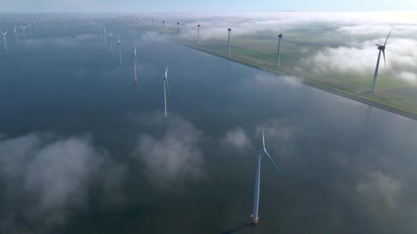 Wind turbines in the early morning, wind mill park in the Netherlands. Wind turbine from aerial view, Drone view at windpark westermeerdijk a windmill farm in the lake IJsselmeer the biggest in the — Stock Video