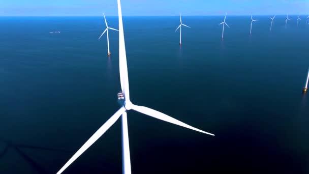 Wind turbines in the early morning, wind mill park in the Netherlands. Wind turbine from aerial view, Drone view at windpark westermeerdijk a windmill farm in the lake IJsselmeer the biggest in the — Stock Video