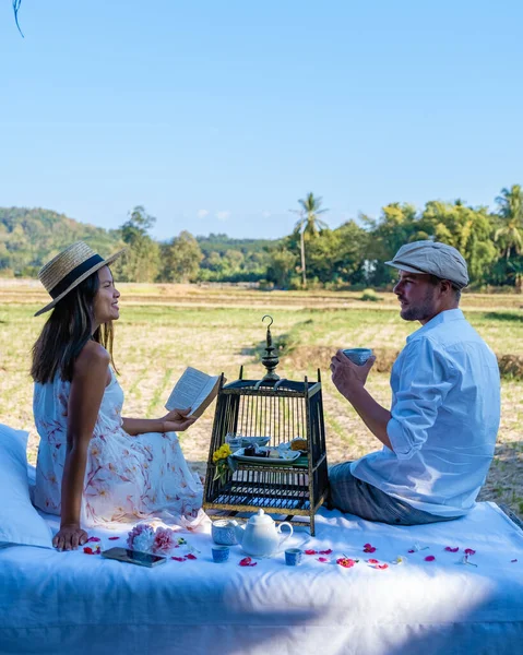 Couple man and woman on vacation in Nan Thailand drinking coffee and high tea with a look over the countryside of Nan Thailand — 스톡 사진