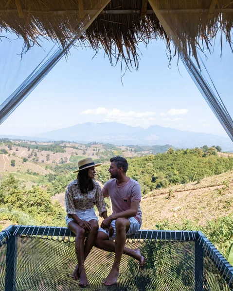 Couple man and woman on vacation in Nan Thailand drinking coffee and high tea with a look over the countryside of Nan Thailand — 스톡 사진