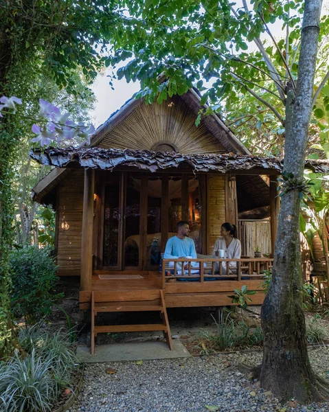 Couple man and woman in front of bamboo hut in Northern Thailand — Photo