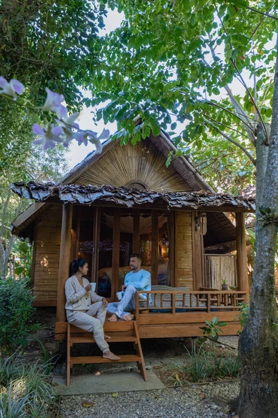 Couple man and woman in front of bamboo hut in Northern Thailand — 스톡 사진