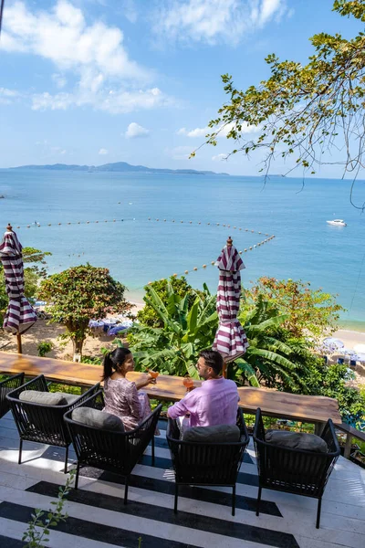 Bir çift, Pattaya Tayland Okyanusu 'na bakan bir restoranda öğle yemeği yiyor. Kadın ve erkek, Pattaya' da okyanus kenarında bir restoranda yemek yiyor. — Stok fotoğraf