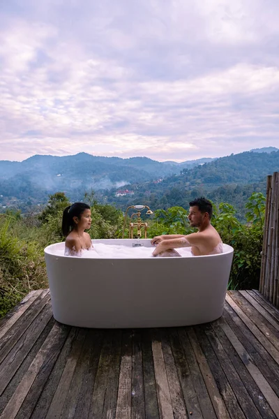 Gün batımında, Chiang Mai Tayland 'ın dağlarında banyo küveti, vahşi doğada, ağaçların arasında jakuzide esneme hareketi. — Stok fotoğraf