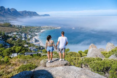 Cape Town 'daki The Rock bakış açısıyla Campsbay' ın üzerinden, Kamp Koyu 'nun üzerinden okyanus üstü sisli