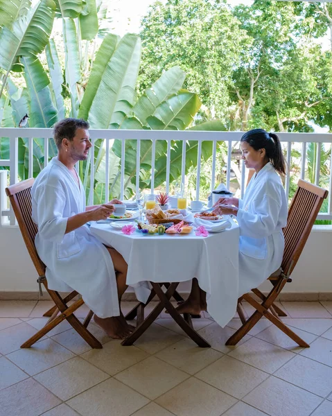 Couple man and woman mid age having breakfast on their balcony of an appartment luxury hotel condo in Mauritius — 스톡 사진