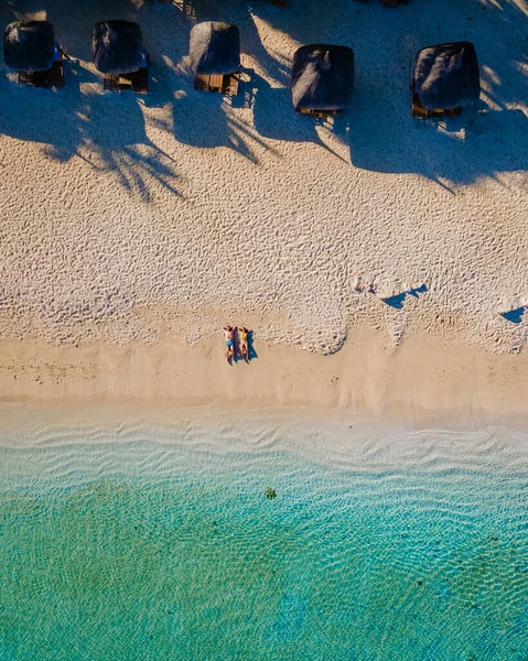 Drone aerial view of a tropical beach, men and woman walking a tropical beach in Mauritius — Zdjęcie stockowe