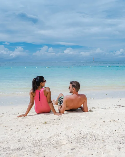 Le Morne beach Mauritius,Tropical beach with palm trees and white sand blue ocean couple men and woman walking at the beach during vacation — Foto Stock