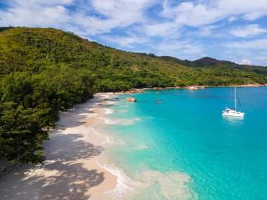 Praslin Seychelles tropical island with withe beaches and palm trees, Anse Lazio beach,Palm tree stands over deserted tropical island dream beach in Anse Lazio, Seychelles. 