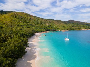 Praslin Seychelles tropical island with withe beaches and palm trees, Anse Lazio beach,Palm tree stands over deserted tropical island dream beach in Anse Lazio, Seychelles. 