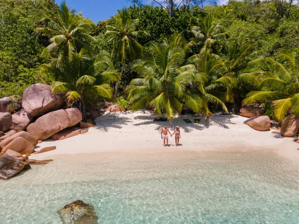 Praslin Seszele tropikalna wyspa z żwirowymi plażami i palmami, para mężczyzn i kobiet w średnim wieku na wakacjach na Seszelach zwiedzanie tropikalnej plaży Anse Lazio Praslin Seszele widok drona — Zdjęcie stockowe