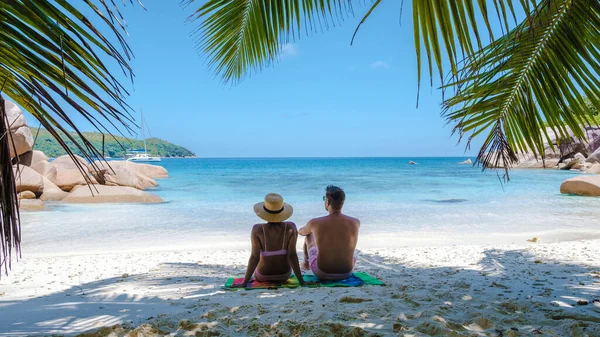Praslin Seychelles tropical island with withe beaches and palm trees, couple men and women mid age on vacation at the Seychelles visiting the tropical beach of Anse Lazio Praslin Seychelles drone view — ストック写真