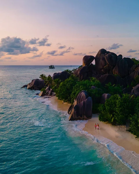 Anse Source dArgent beach, La Digue Island, Seyshelles, Drone aerial view of La Digue Seychelles bird eye view, couple men and woman walking at the beach during sunset at a luxury vacation — ストック写真