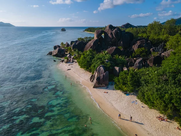 Anse Source dArgent beach, La Digue Island, Seyshelles, Drone aerial view of La Digue Seychelles bird eye view, couple men and woman walking at the beach during sunset at a luxury vacation — Photo