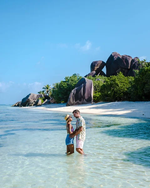 Anse Source dArgent beach, La Digue Island, Seyshelles, Drone aerial view of La Digue Seychelles bird eye view, couple men and woman walking at the beach during sunset at a luxury vacation — Stockfoto