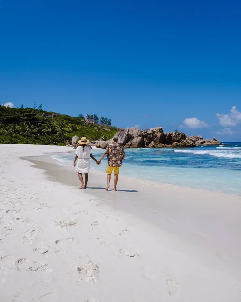 Anse Cocos beach, La Digue Island, Seyshelles, Drone aerial view of La Digue Seychelles bird eye view, couple men and woman walking at the beach during sunset at a luxury vacation — Photo