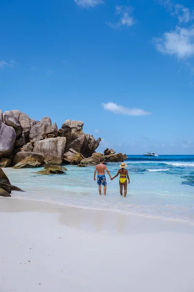 Anse Cocos beach, La Digue Island, Seyshelles, Drone aerial view of La Digue Seychelles bird eye view, couple men and woman walking at the beach during sunset at a luxury vacation — ストック写真