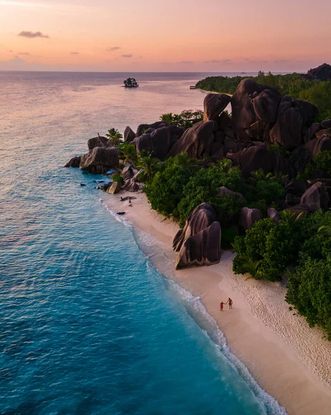 Anse Source dArgent beach, La Digue Island, Seyshelles, Drone aerial view of La Digue Seychelles bird eye view, couple men and woman walking at the beach during sunset at a luxury vacation — 图库照片