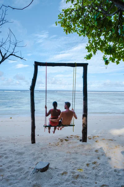 Anse Source dArgent beach, La Digue Island, Seyshelles, Drone aerial view of La Digue Seychelles bird eye view, couple men and woman walking at the beach during sunset at a luxury vacation — Foto de Stock