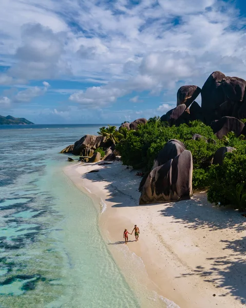 Anse Source dArgent beach, La Digue Island, Seyshelles, Drone aerial view of La Digue Seychelles bird eye view, couple men and woman walking at the beach during sunset at a luxury vacation — Zdjęcie stockowe