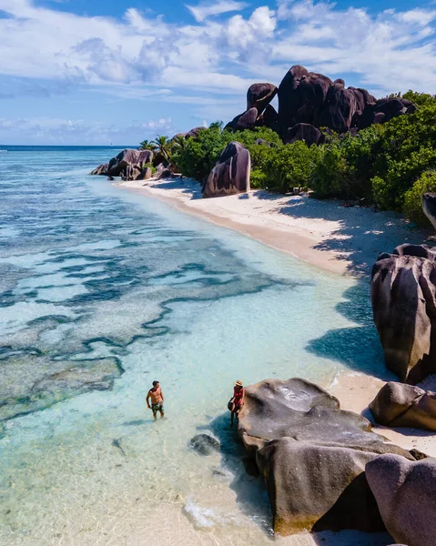Anse Source dArgent beach, La Digue Island, Seyshelles, Drone aerial view of La Digue Seychelles bird eye view, couple men and woman walking at the beach during sunset at a luxury vacation — Foto Stock