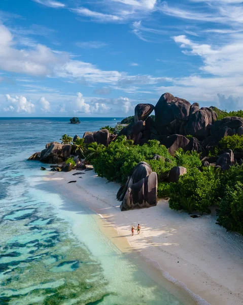 Anse Source dArgent beach, La Digue Island, Seyshelles, Drone aerial view of La Digue Seychelles bird eye view, couple men and woman walking at the beach during sunset at a luxury vacation — Foto Stock