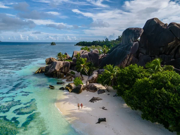 Anse Source dArgent beach, La Digue Island, Seyshelles, Drone aerial view of La Digue Seychelles bird eye view, couple men and woman walking at the beach during sunset at a luxury vacation — Foto Stock