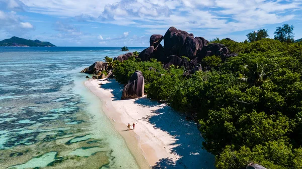 Anse Source dArgent beach, La Digue Island, Seyshelles, Drone aerial view of La Digue Seychelles bird eye view, couple men and woman walking at the beach during sunset at a luxury vacation —  Fotos de Stock