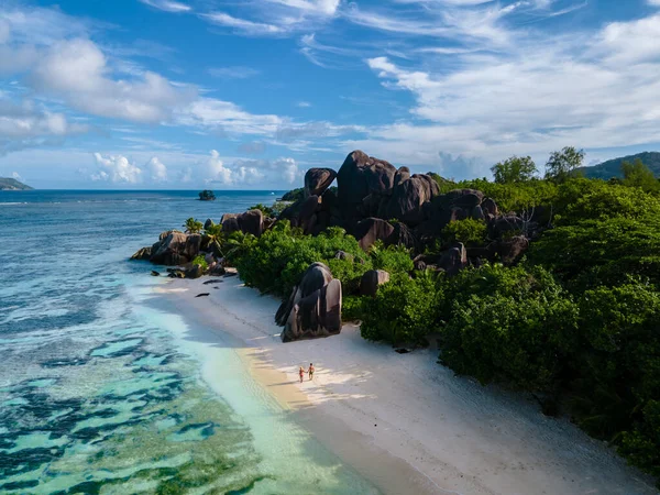 Anse Source dArgent beach, La Digue Island, Seyshelles, Drone aerial view of La Digue Seychelles bird eye view, couple men and woman walking at the beach during sunset at a luxury vacation — Photo