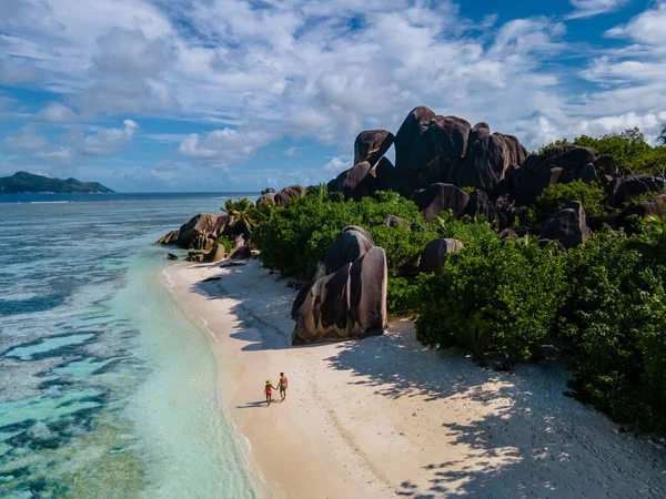 Anse Source dArgent beach, La Digue Island, Seyshelles, Drone aerial view of La Digue Seychelles bird eye view, couple men and woman walking at the beach during sunset at a luxury vacation — 图库照片