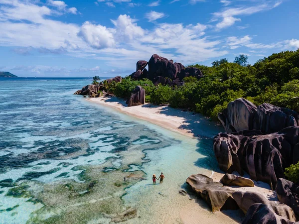 Anse Source dArgent beach, La Digue Island, Seyshelles, Drone aerial view of La Digue Seychelles bird eye view, couple men and woman walking at the beach during sunset at a luxury vacation — Zdjęcie stockowe