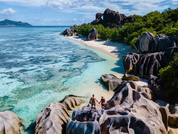 Anse Source dArgent beach, La Digue Island, Seyshelles, Drone aerial view of La Digue Seychelles bird eye view, couple men and woman walking at the beach during sunset at a luxury vacation — Zdjęcie stockowe