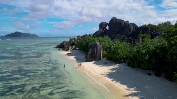 Anse Source dArgent beach, La Digue Island, Seyshelles, Drone Αεροφωτογραφία του La Digue Seychelles bird eye view, ζευγάρι ανδρών και γυναικών που περπατούν στην παραλία κατά τη διάρκεια του ηλιοβασιλέματος σε πολυτελείς διακοπές — Αρχείο Βίντεο