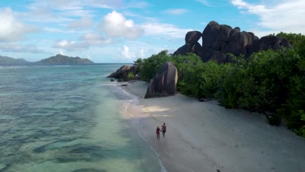 Anse Source dArgent beach, La Digue Island, Seyshelles, Drone Αεροφωτογραφία του La Digue Seychelles bird eye view, ζευγάρι ανδρών και γυναικών που περπατούν στην παραλία κατά τη διάρκεια του ηλιοβασιλέματος σε πολυτελείς διακοπές — Αρχείο Βίντεο