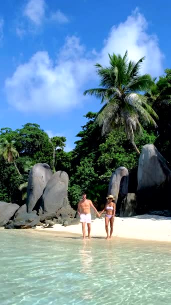 Anse Takamaka praia Mahe Seychelles, praia tropical com palmeiras e um oceano azul, casal homem e mulher na praia — Vídeo de Stock