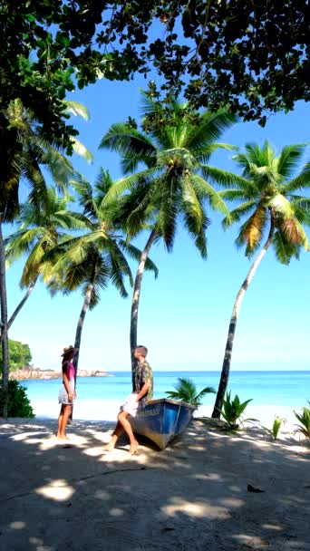 Anse Takamaka beach Mahe Seychelles, tropical beach with palm trees and a blue ocean, couple man and woman on the beach — Stockvideo