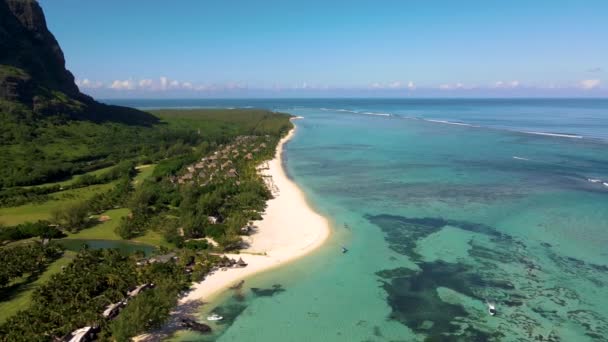 Le Morne beach Mauritius,Tropical beach with palm trees and white sand blue ocean and beach beds with umbrella,Sun chairs and parasol under a palm tree at a tropical beac, Le Morne beach Mauritius — Stok video