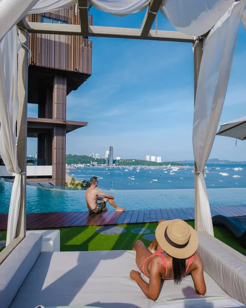 Couple man and woman on a luxury vacation enjoying the infinity pool on the rooftop, Pattaya Thailand — Fotografia de Stock