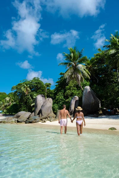 Mahe Seychelles, tropical beach with palm trees and a blue ocean at Mahe Seychelles Anse Royale beach, couple man and woman on vacation Seychelles — Stockfoto