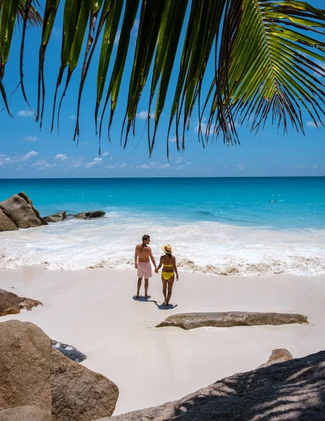 Anse Georgette Praslin Seychelles, young couple men and woman on a tropical beach during a luxury vacation in the Seychelles. Tropical beach Anse Georgette Praslin Seychelles — Stockfoto