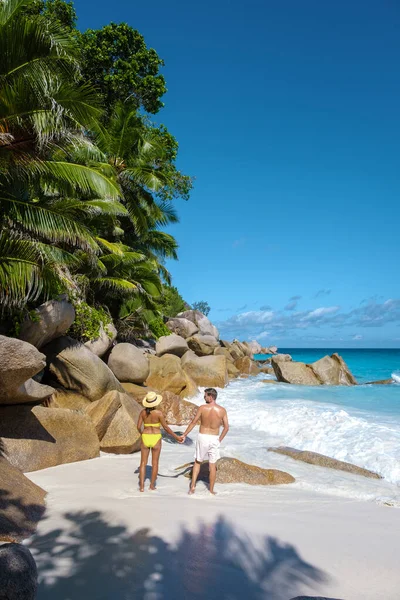 Anse Georgette Praslin Seszele, młoda para mężczyzn i kobiet na tropikalnej plaży podczas luksusowych wakacji na Seszelach. Tropikalna plaża Anse Georgette Praslin Seszele — Zdjęcie stockowe