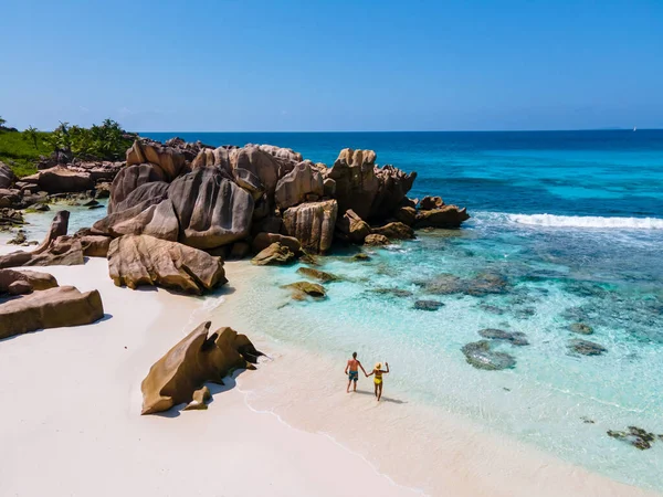 Anse Cocos La Digue Seychelles, young couple men and woman on a tropical beach during a luxury vacation in the Seychelles. Tropical beach Anse Cocos La Digue Seychelles — ストック写真
