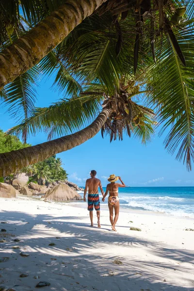 Anse Patates, La Digue Seychellen, jong stel mannen en vrouw op een tropisch strand tijdens een luxe vakantie op de Seychellen. Tropisch strand Anse Patates, La Digue Seychellen — Stockfoto