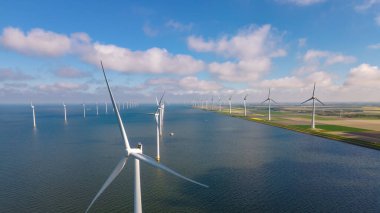 Huge windmill turbines, Offshore Windmill farm in the ocean Westermeerwind park , windmills isolated at sea on a beautiful bright day Netherlands Flevoland Noordoostpolder