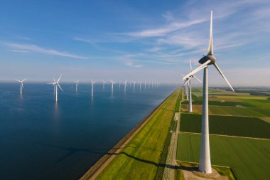 Huge windmill turbines, Offshore Windmill farm in the ocean Westermeerwind park , windmills isolated at sea on a beautiful bright day Netherlands Flevoland Noordoostpolder