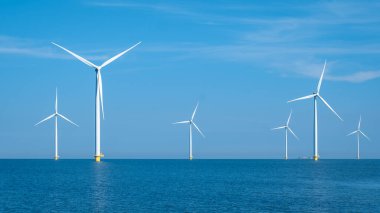 Huge windmill turbines, Offshore Windmill farm in the ocean Westermeerwind park , windmills isolated at sea on a beautiful bright day Netherlands Flevoland Noordoostpolder