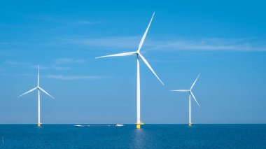 Huge windmill turbines, Offshore Windmill farm in the ocean Westermeerwind park , windmills isolated at sea on a beautiful bright day Netherlands Flevoland Noordoostpolder