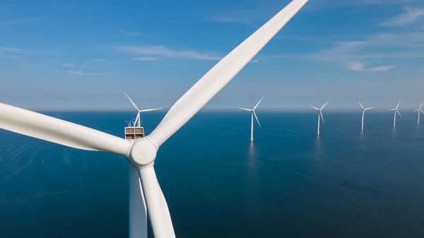 Huge windmill turbines, Offshore Windmill farm in the ocean Westermeerwind park , windmills isolated at sea on a beautiful bright day Netherlands Flevoland Noordoostpolder — Stok fotoğraf