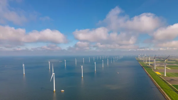 Huge windmill turbines, Offshore Windmill farm in the ocean Westermeerwind park , windmills isolated at sea on a beautiful bright day Netherlands Flevoland Noordoostpolder — стокове фото