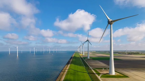 Huge windmill turbines, Offshore Windmill farm in the ocean Westermeerwind park , windmills isolated at sea on a beautiful bright day Netherlands Flevoland Noordoostpolder — Fotografia de Stock